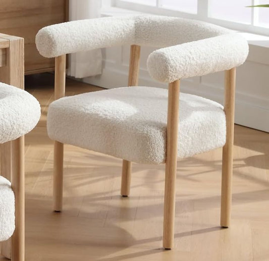 White cushioned chairs with wooden legs on a wooden floor.
