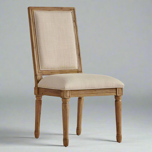 Wooden chair with beige cushioned seat and backrest on a white background