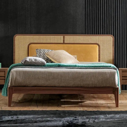 Modern bedroom with a bed, nightstands, and decorative pillows against a dark wall.