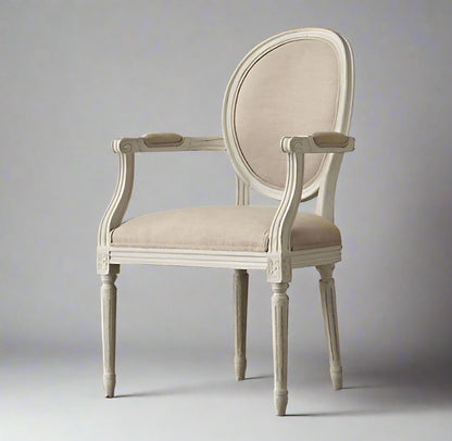 Vintage-style chair with beige cushioned seat and backrest on a wooden floor.