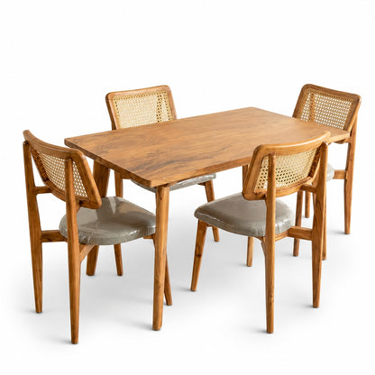 Wooden dining table with four matching chairs on a white background