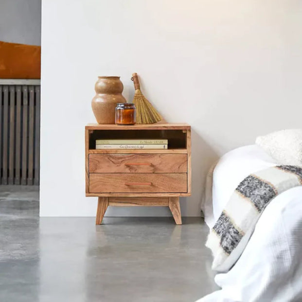Wooden nightstand with decorative items in a bedroom setting