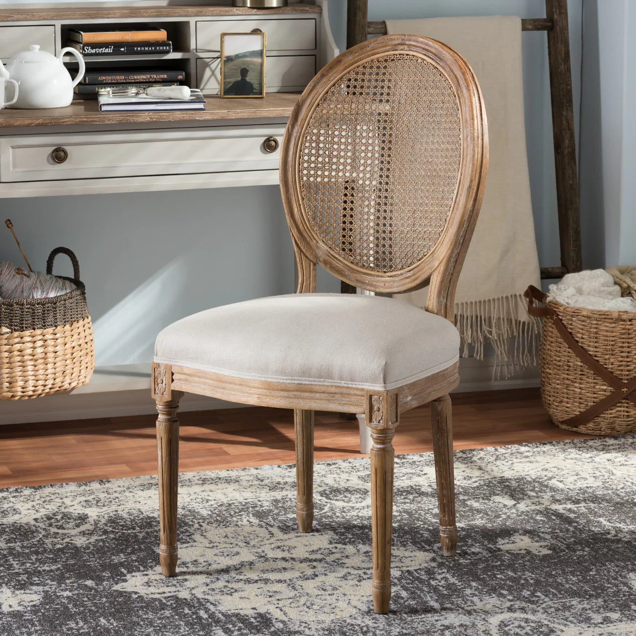 Wooden chair with wicker backrest in a room setting with a desk and baskets.