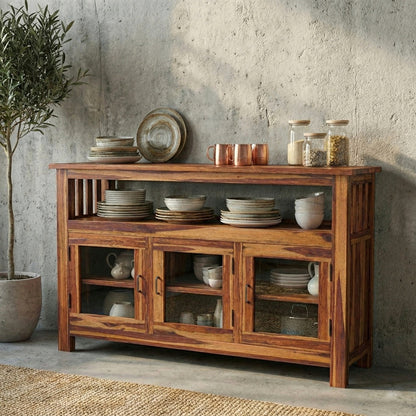 Wooden sideboard with decorative items against a concrete wall