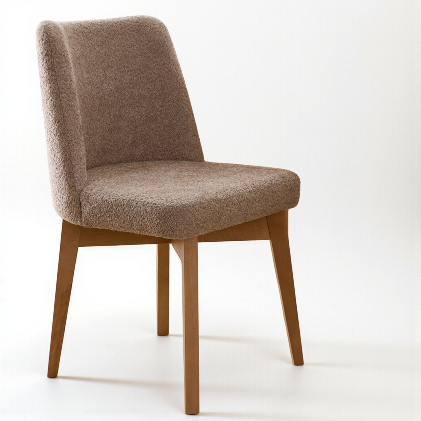 Brown upholstered chair with wooden legs on a white background