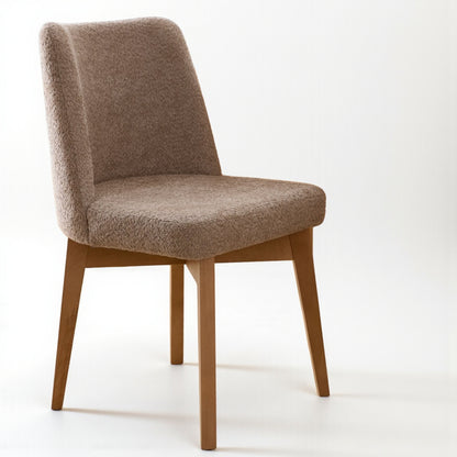 Brown upholstered chair with wooden legs on a white background