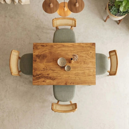 Wooden dining table with chairs in a minimalistic room.