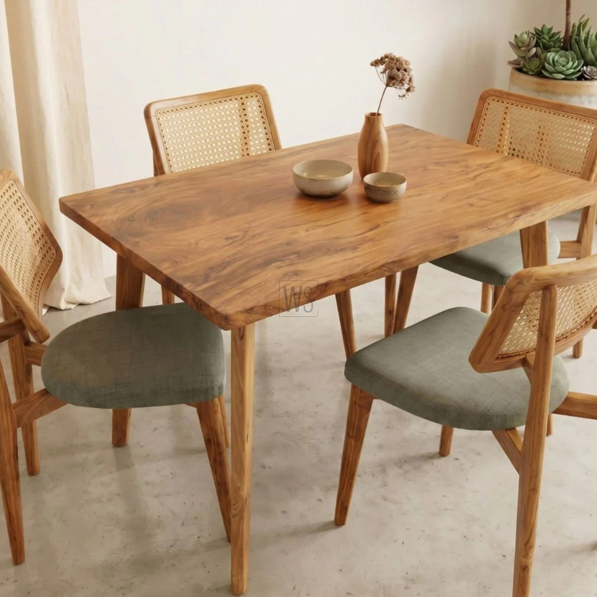 Wooden dining table with chairs in a room setting